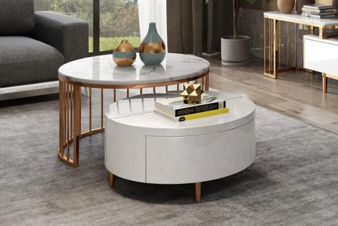 Round coffee table with marble top and wooden legs in a living room.