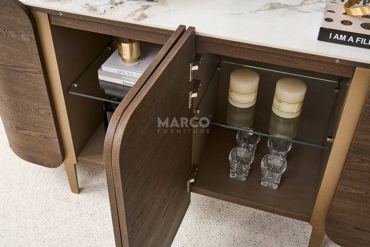 Wooden cabinet with open door revealing interior shelves and decor items, branded 'Marco Furniture'.