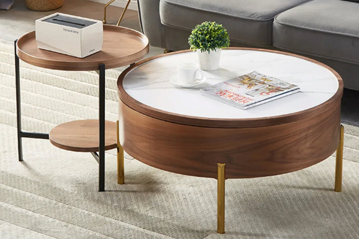 Round wooden coffee table with white top in a living room.