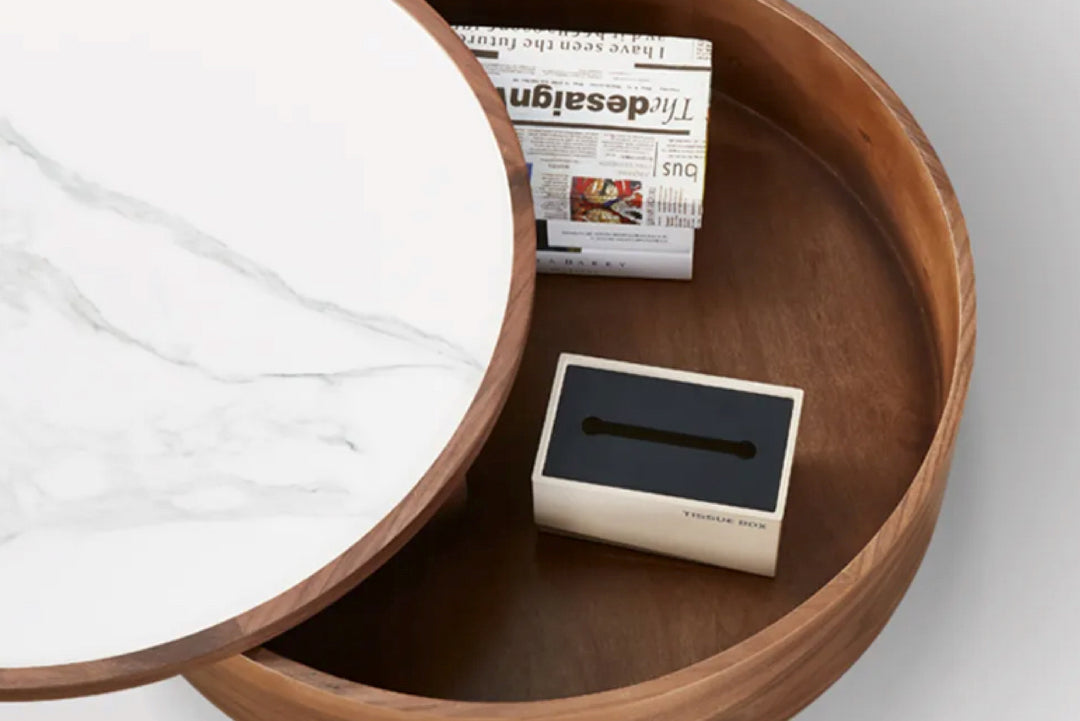 Wooden tray with white cloth, newspaper, and black box on a light background