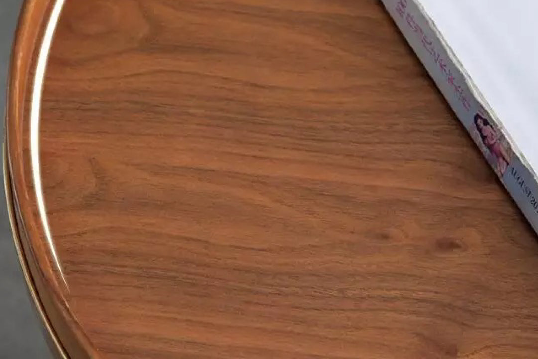 Close-up of a wooden surface with a book edge.