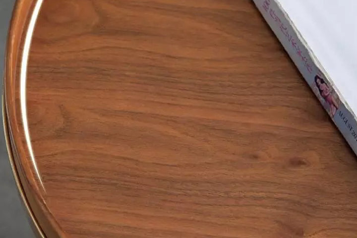 Close-up of a wooden surface with a book edge.