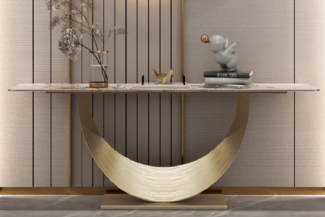 Modern console table with marble top and decorative items against a wall with vertical stripes.