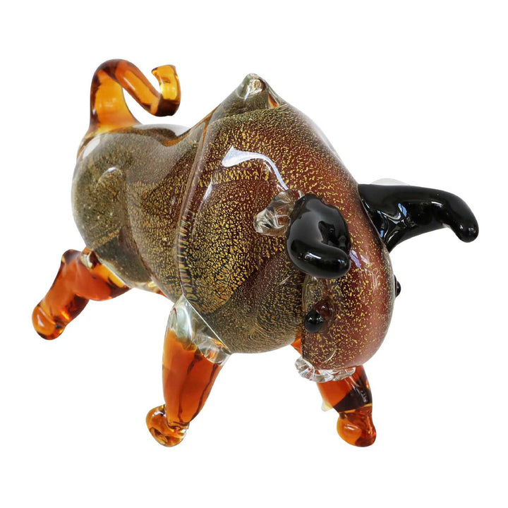 Glass sculpture of a dog with brown, black, and orange colors on a white background