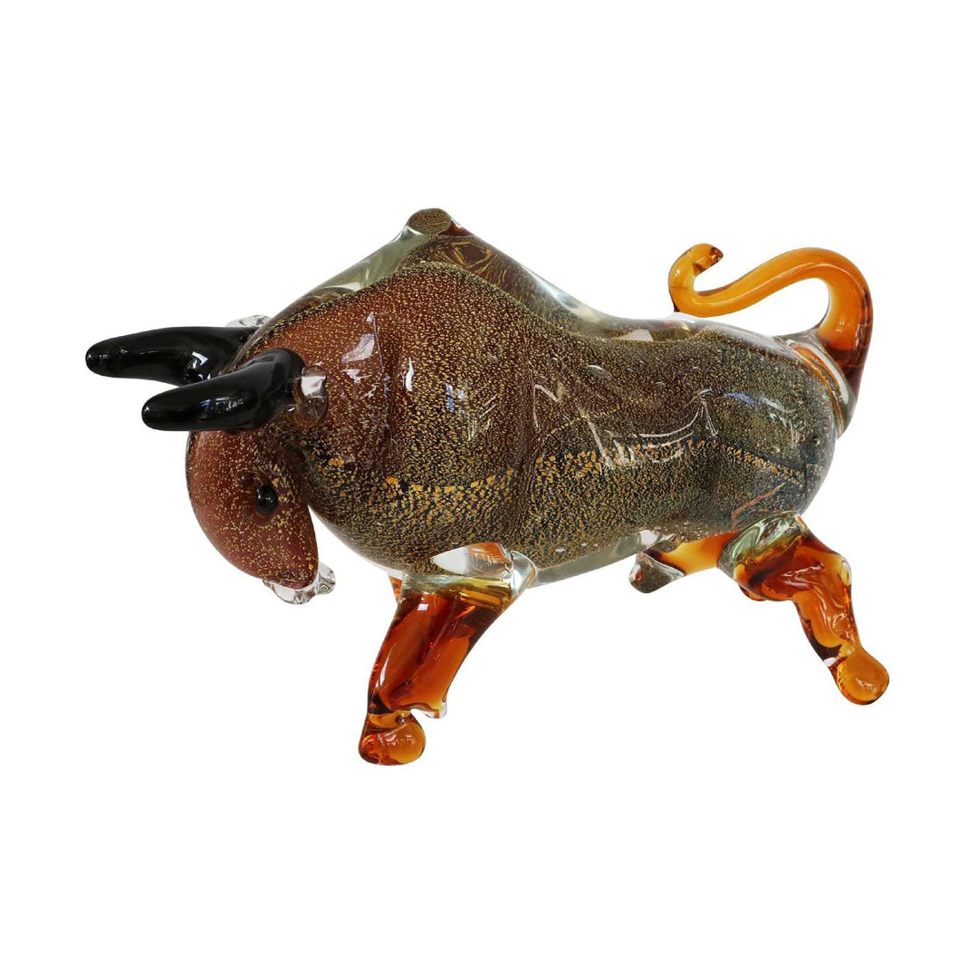 Glass buffalo figure with black horns and orange legs on a white background