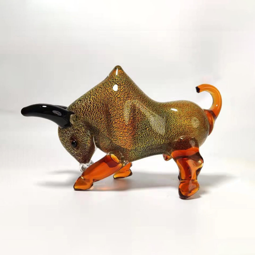 Glass bull figurine with brown and orange colors on a white background