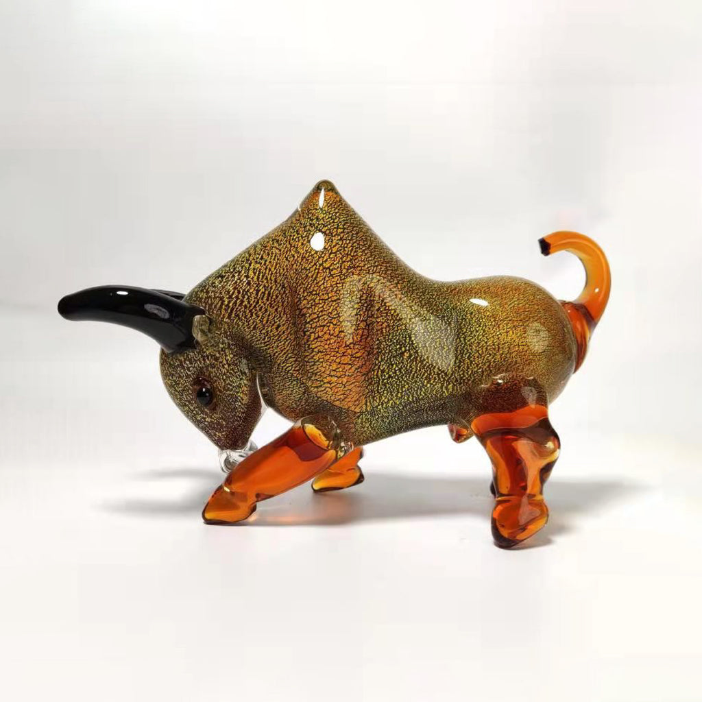 Glass bull figurine with brown and orange colors on a white background