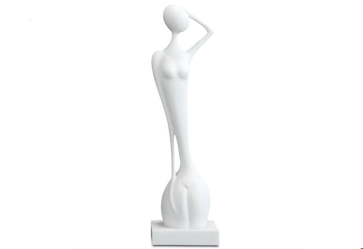 A white sandstone sculpture of a naked lady statue with flowing curves, displayed on a pedestal.
