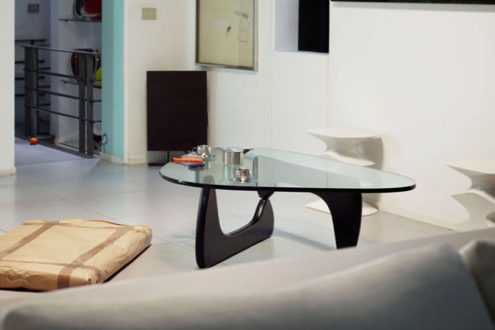 Modern glass coffee table in a living room setting.