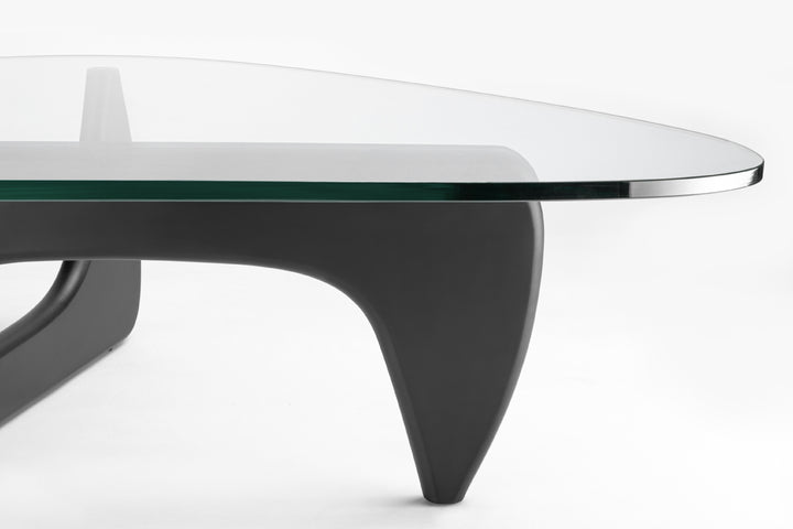 Glass coffee table with black metal legs on a white background