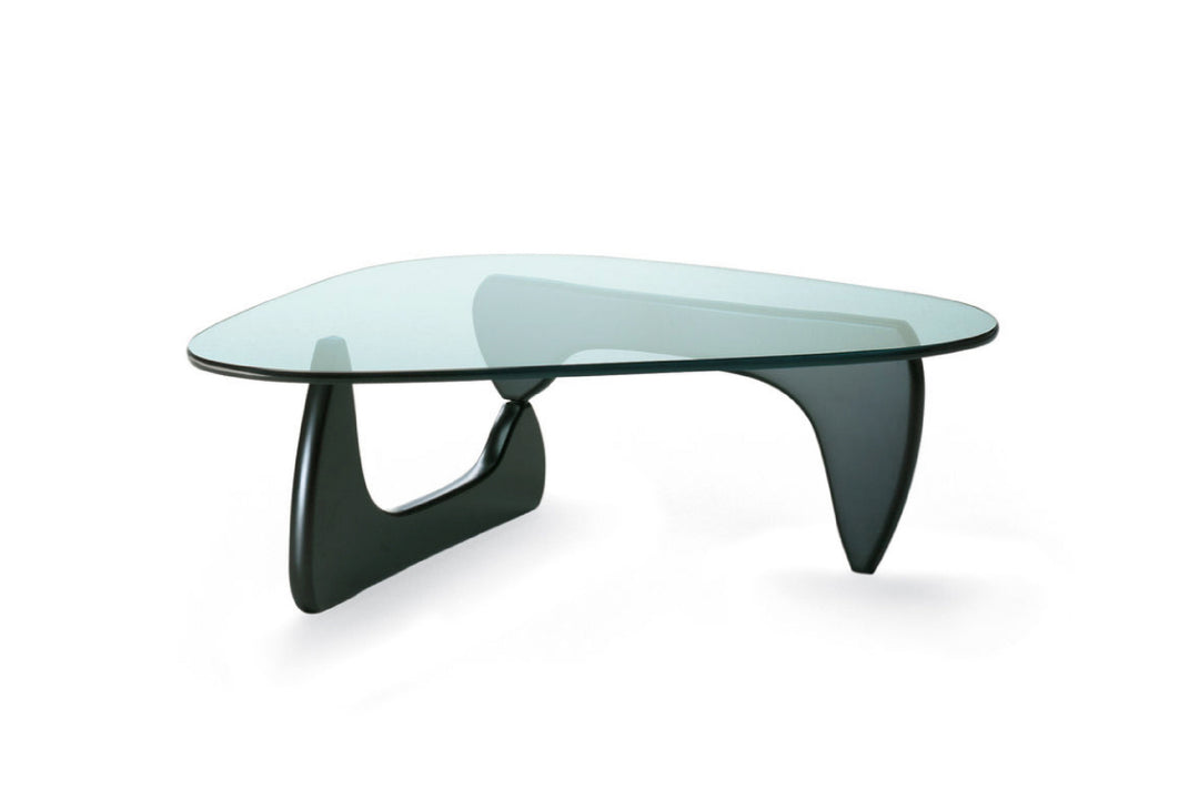 Modern glass coffee table with black metal base on white background