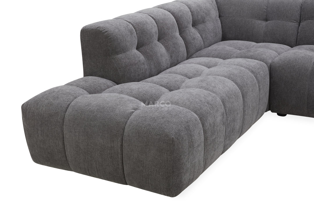 Gray tufted sectional sofa on a white background