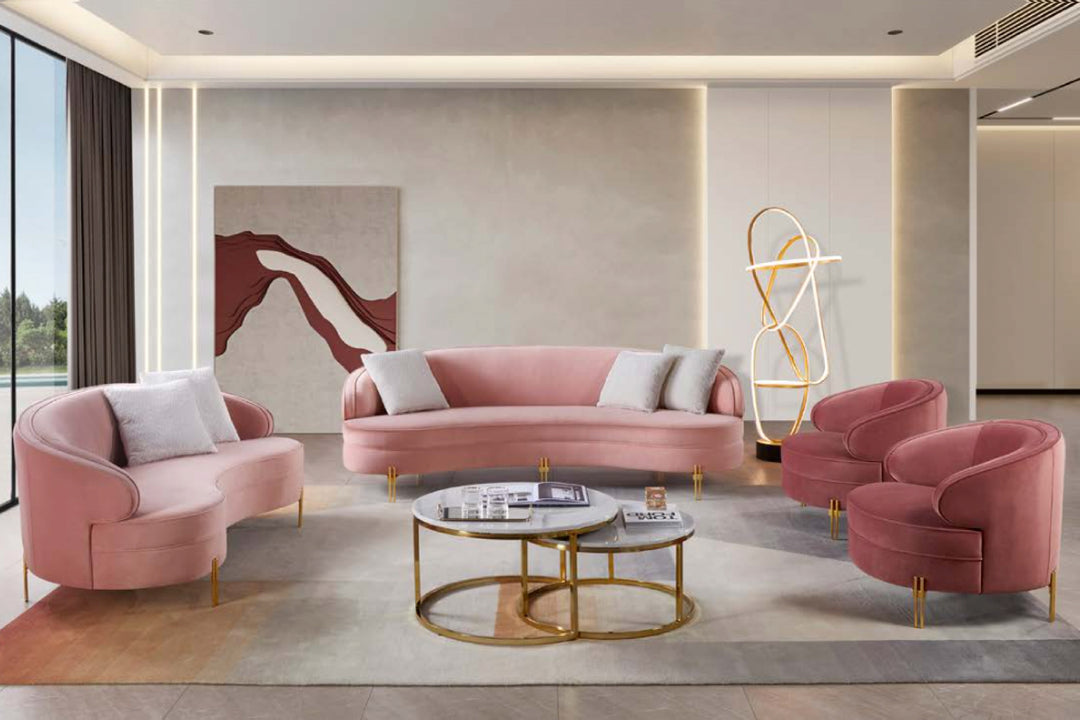 Modern living room with pink sofa and chairs, gold coffee table, and abstract art on the wall.