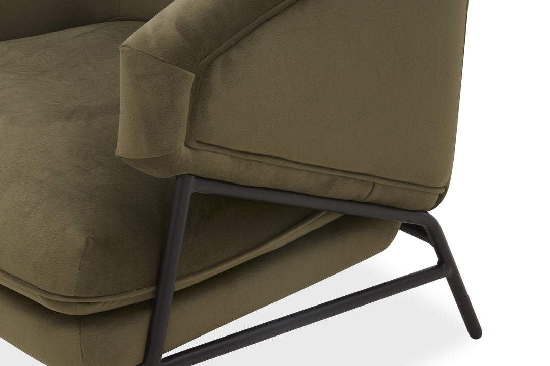 Green upholstered chair with metal legs on a white background