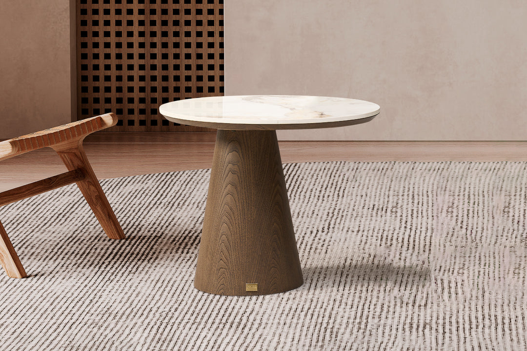 A luxury corner table with a glossy sintered stone top in Pandora Brown color, supported by a cone-shaped base with a natural grain pattern in Toffee Brown color.