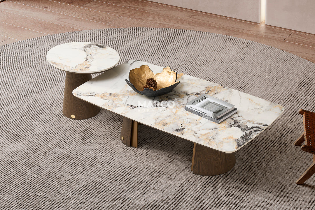 A modern coffee table with a sintered stone tabletop and a dual-layered base with a toffee brown color, placed on a grey rug.