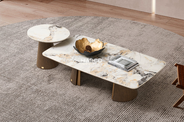 A modern coffee table with a sintered stone tabletop and a dual-layered base with a toffee brown color, placed on a grey rug.