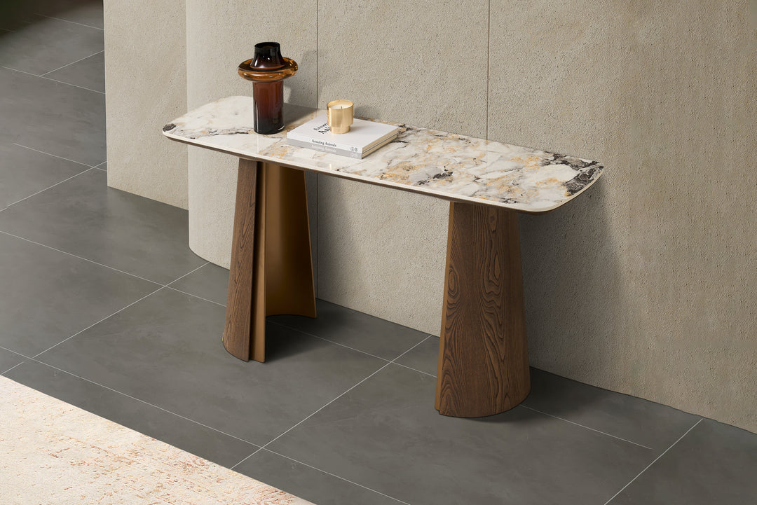 Modern console table with marble top and wooden legs against a tiled wall.