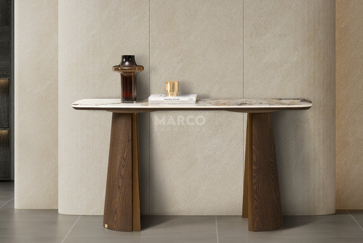 Modern console table with marble top and wooden legs against a neutral wall.