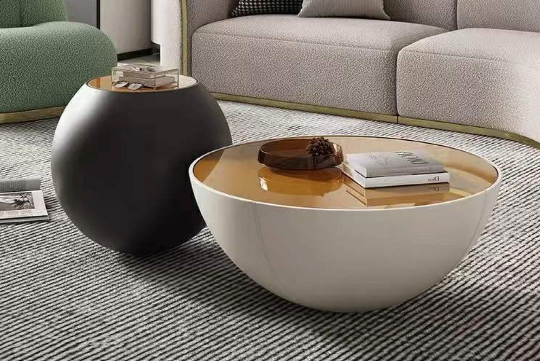 Modern living room with a round white coffee table and a black side table.