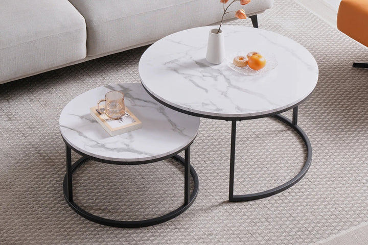 Nested marble coffee tables in a living room setting.
