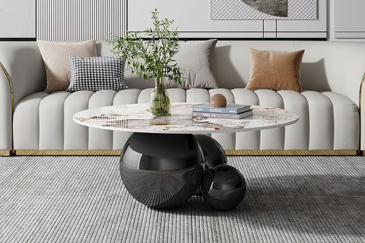 Living room with a gray sofa, decorative pillows, a coffee table, and a vase with plants.