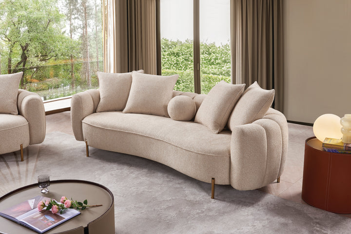 Beige sofa in a modern living room with large windows and curtains.