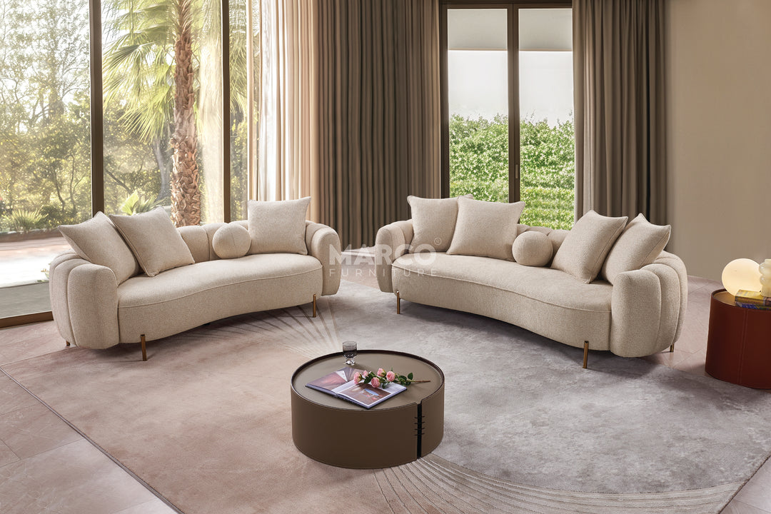 Modern living room with beige sofas and a round coffee table.