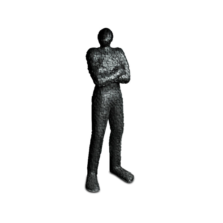 A black mosaic texture sandstone statue of a standing figurine with crossed arms.