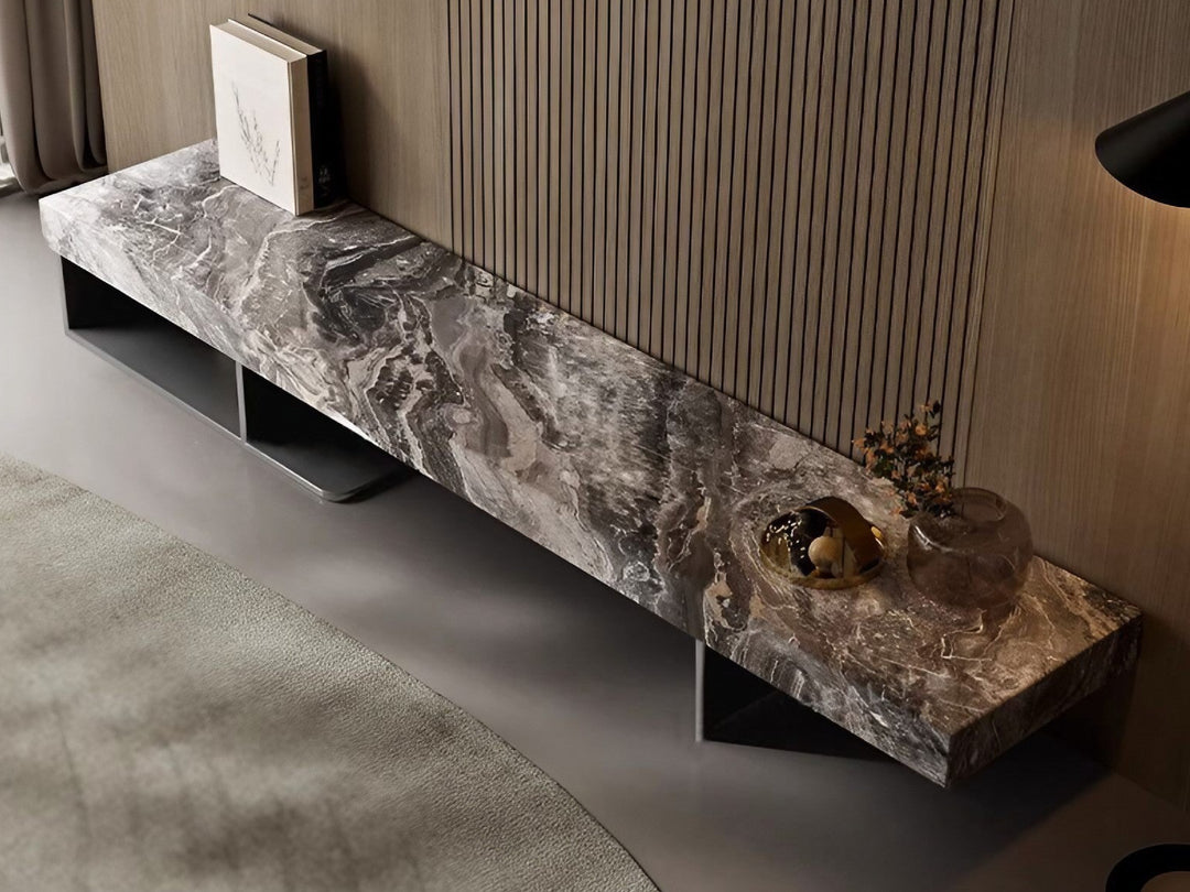 Modern marble console table with decorative items against a neutral background.