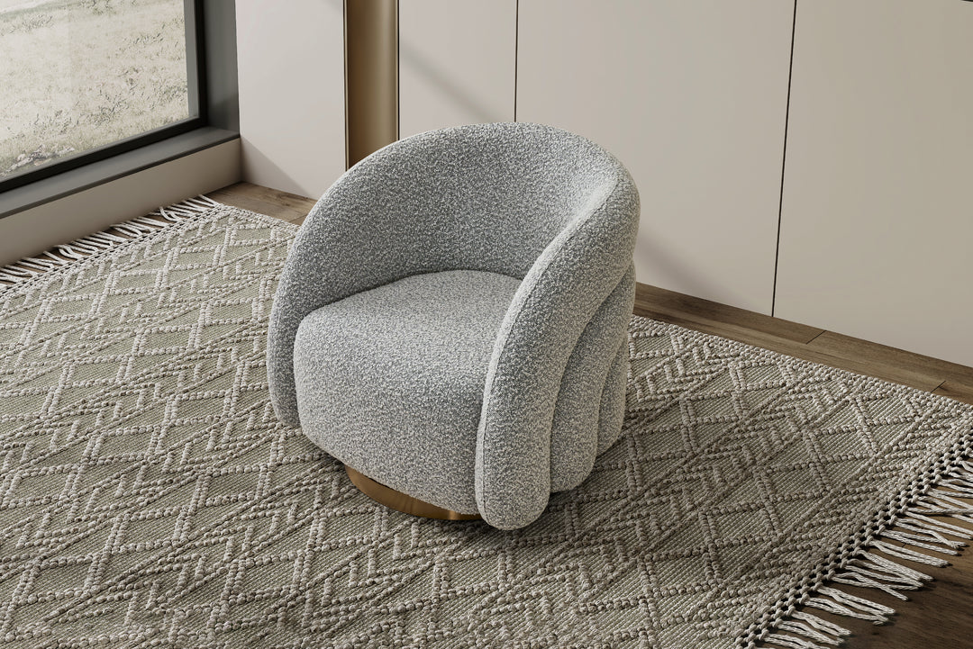 Gray textured armchair on a patterned rug in a room with a window.