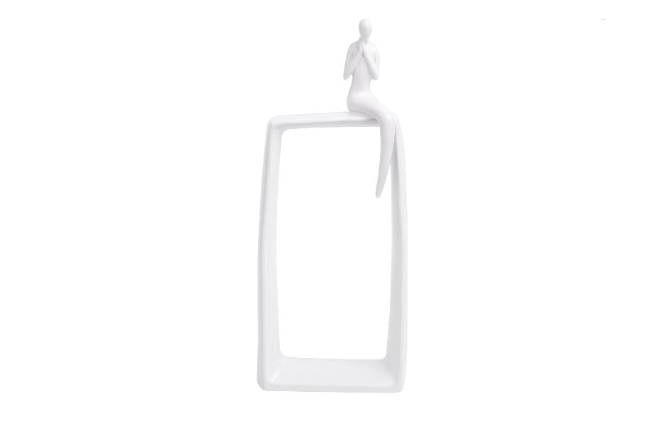 White ceramic abstract art statue featuring a human figure sitting atop a vertical hollow rectangle base.