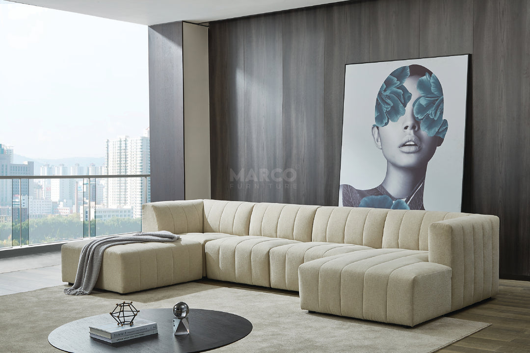 Modern living room with a beige sectional sofa, coffee table, and artwork on the wall.