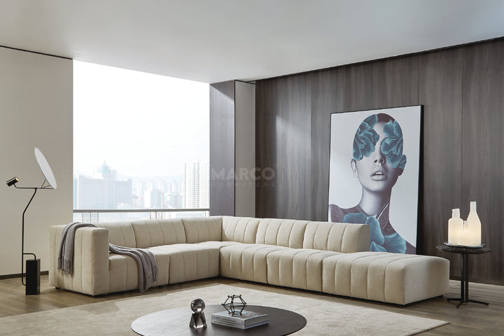 Modern living room with a beige sectional sofa, coffee table, and artwork on the wall.