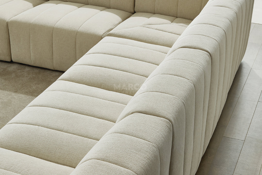 Light green sectional sofa on a wooden floor