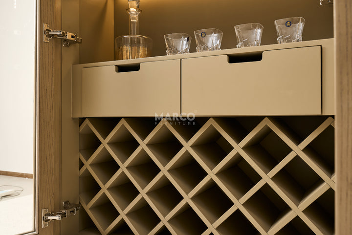 Wine cabinet with wine glasses on top, brand 'Marco' visible