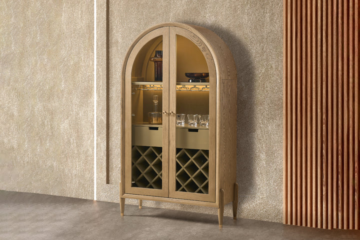 Beige arched cabinet with glass doors against a textured wall.