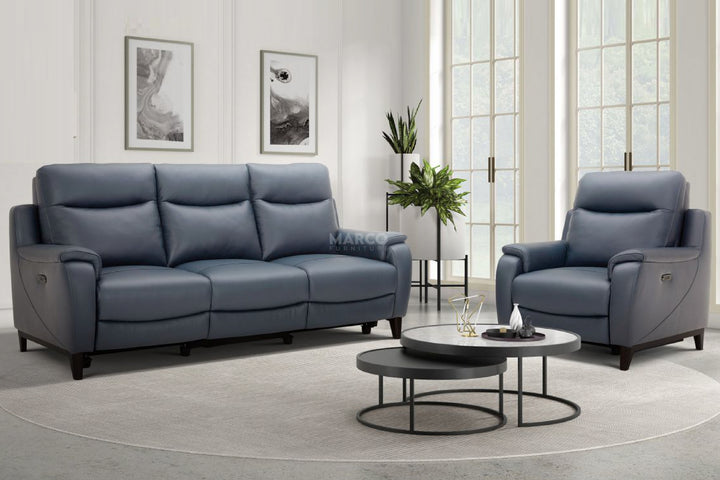 Gray sofa and chair set in a living room with round coffee tables and decor.