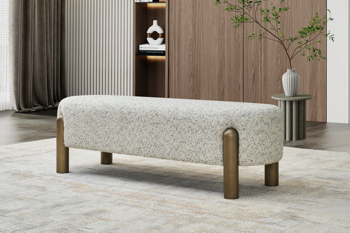 Textured ottoman with wooden legs in a room setting
