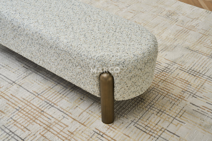Textured ottoman with wooden legs in a room setting