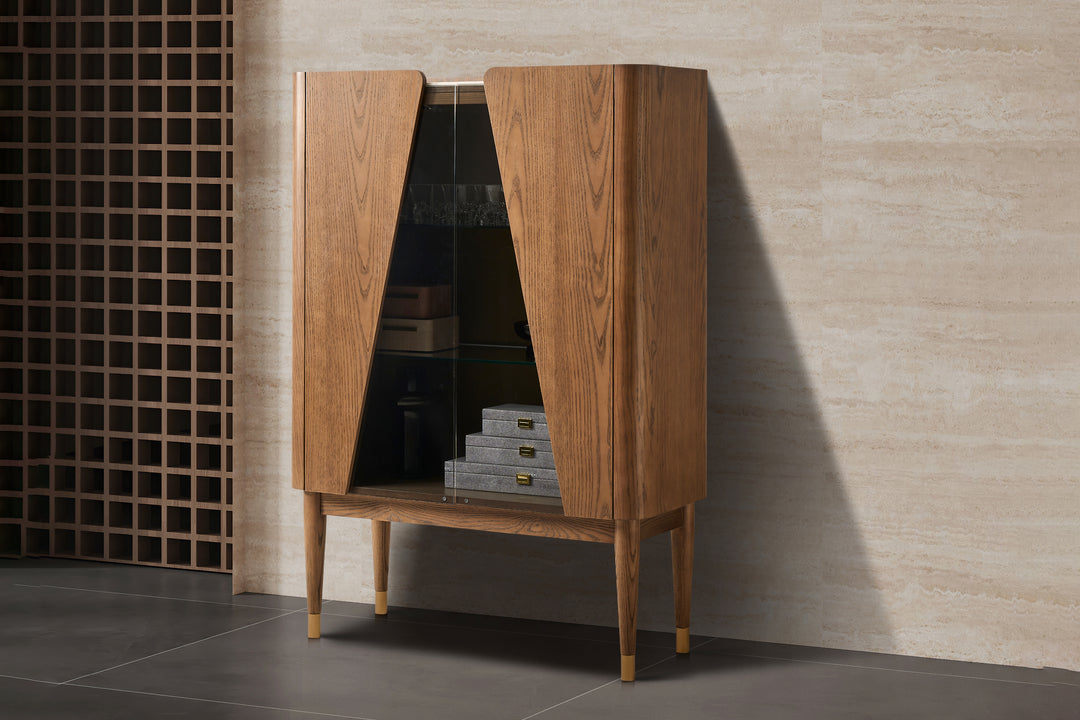 Wooden cabinet with open doors against a tiled wall