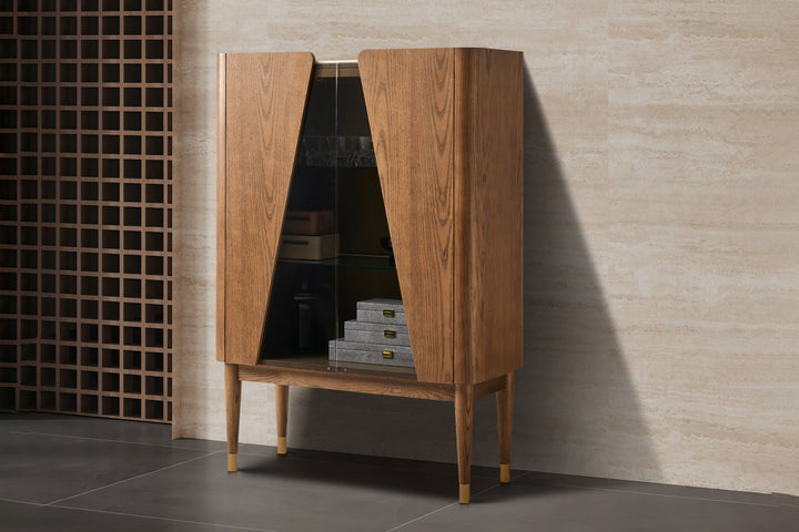 Wooden cabinet with open doors against a tiled wall
