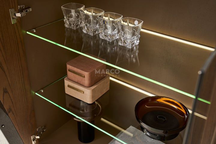 Glassware and decorative items on a shelf with LED lighting