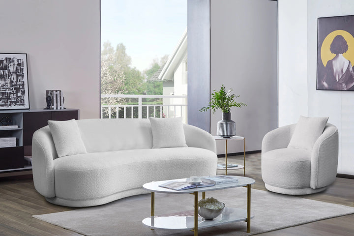 Modern living room with a white sofa, armchair, and coffee table.