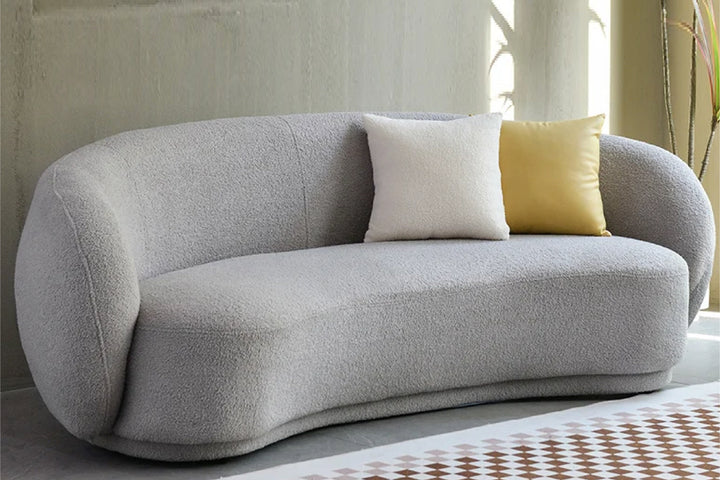 Gray sofa with white and yellow cushions in a modern living room setting
