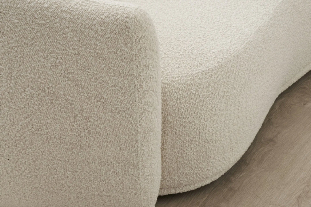 Close-up of textured beige carpet on a wooden floor