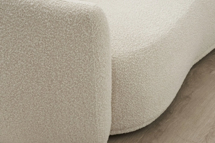 Close-up of textured beige carpet on a wooden floor