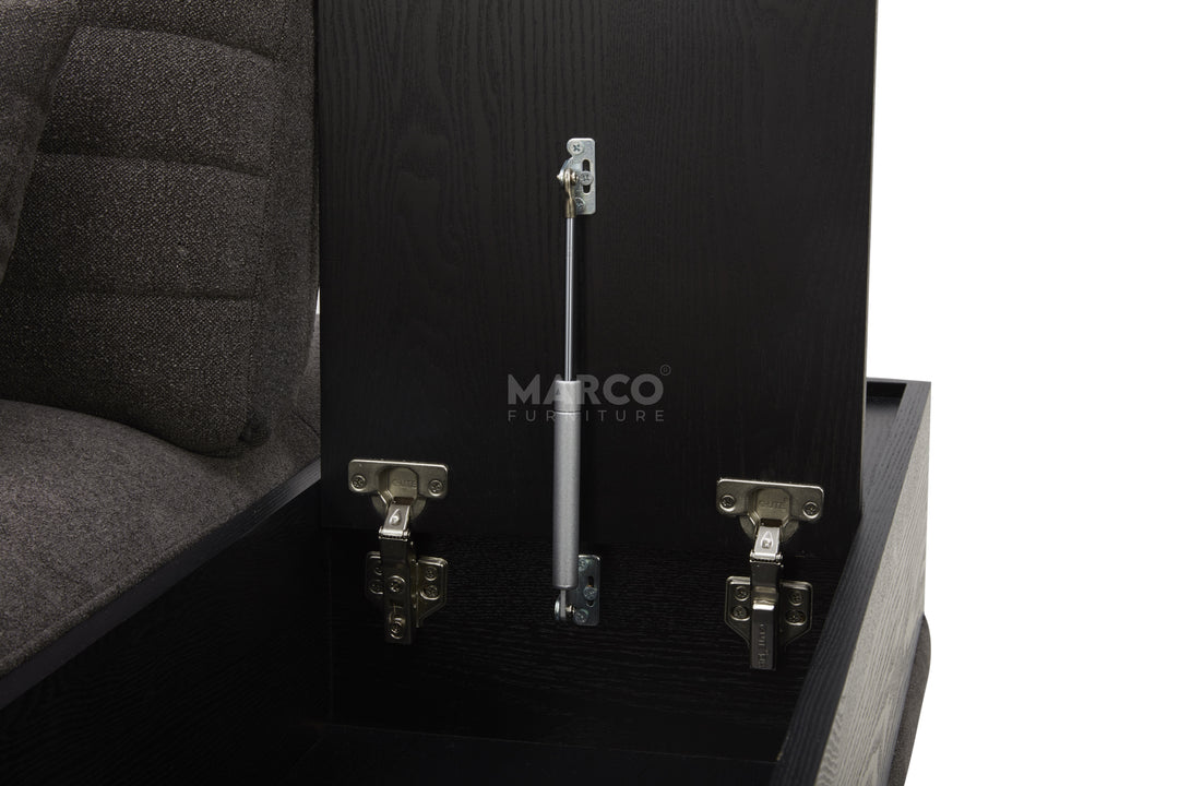 Close-up of a black upholstered chair with metal components and 'Marco' branding.