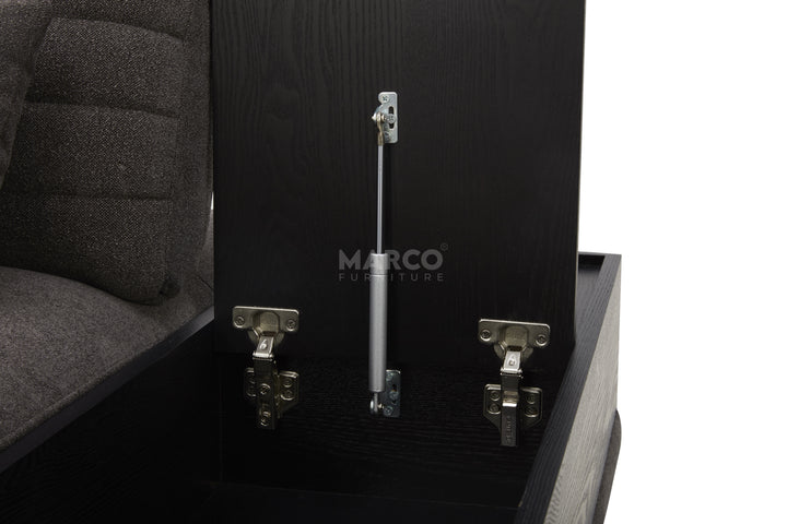 Close-up of a black upholstered chair with metal components and 'Marco' branding.