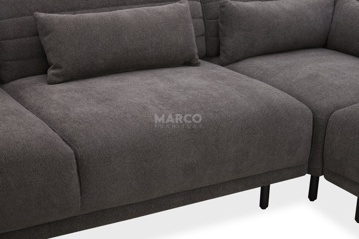 Gray sectional sofa with 'Marco' branding on a white background